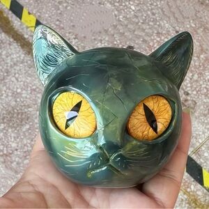 Green Cat Figurine with Yellow Eyes